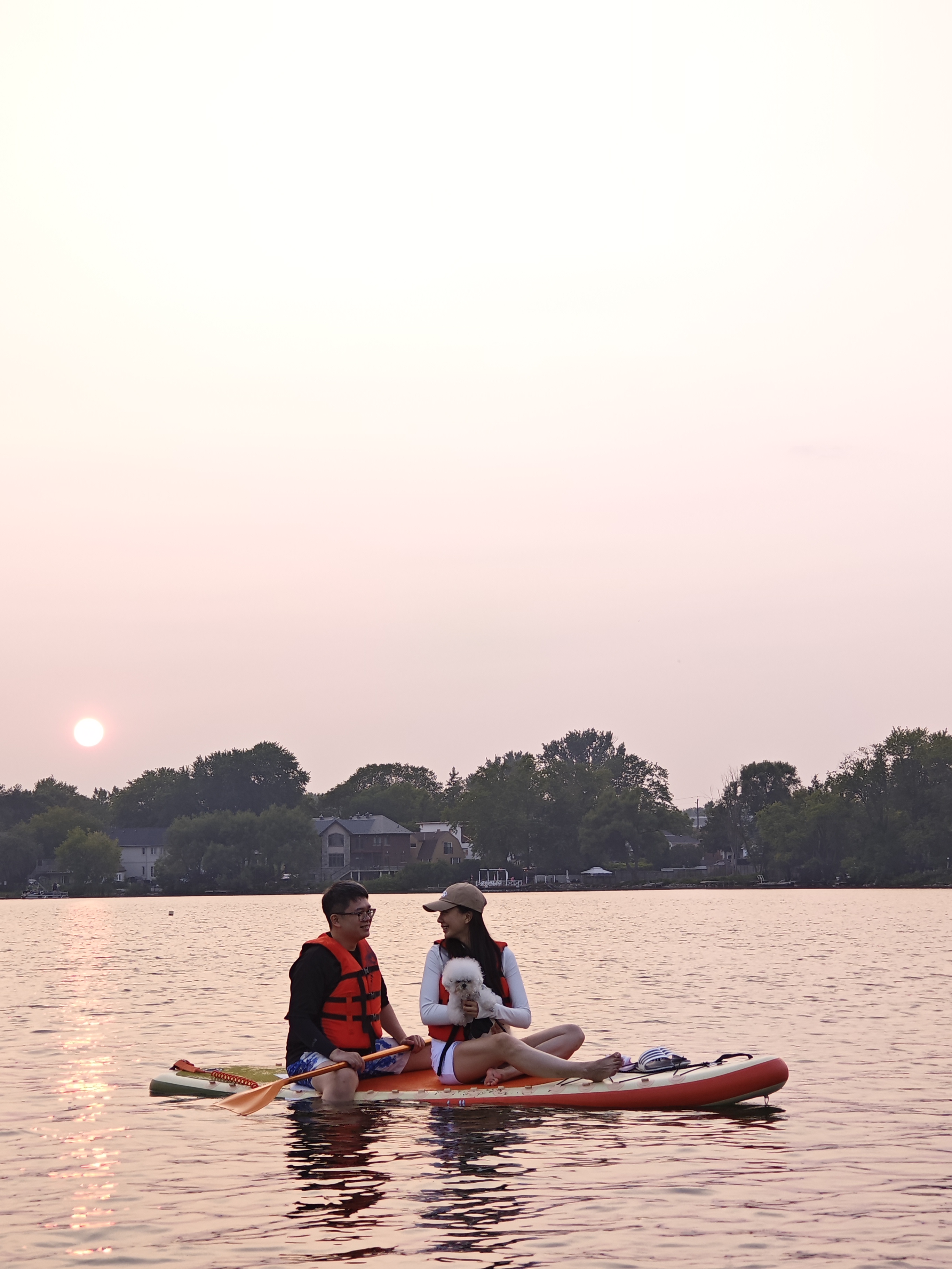 Small-group paddle board lesson on calm evening water