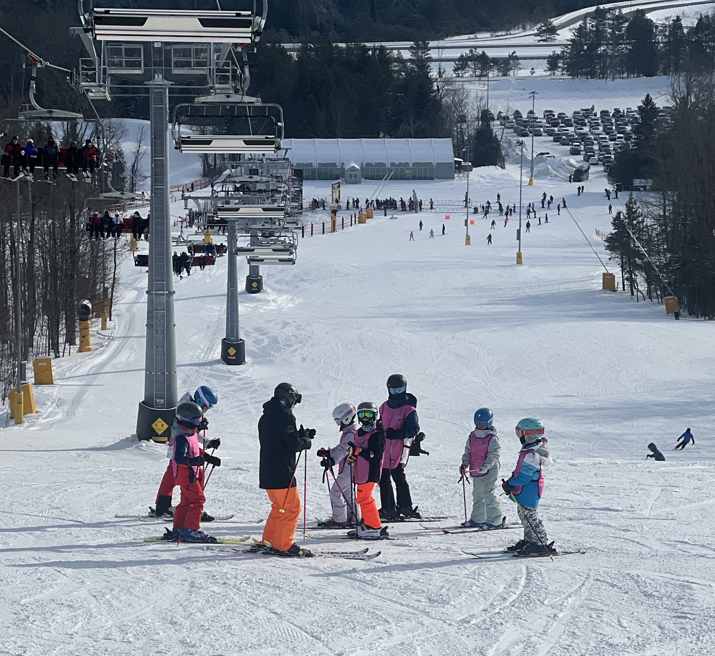 Children and instructors standing together at a ski resort