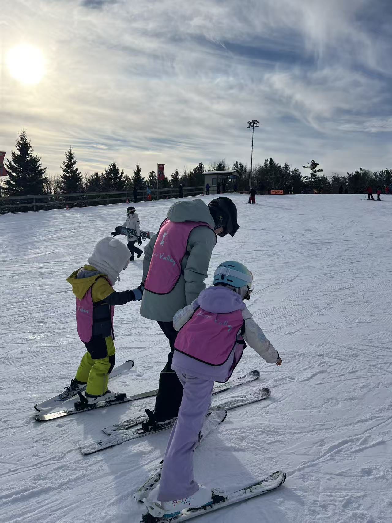 Children and instructors together on a snowy ski slope